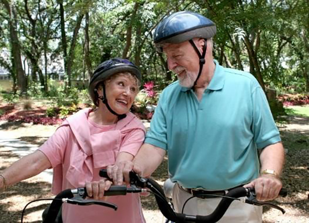 Two seniors riding the bike